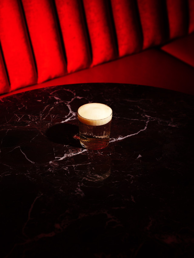 A cocktail set down on the marble
